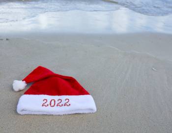 A Santa hat on a beach