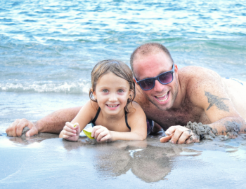 A father and daughter enjoy time on the beach
