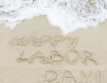 Labor day written in the sand