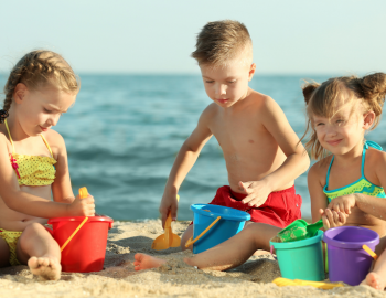 Children building a sandcastle on the beach