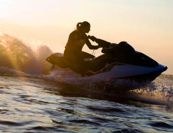 A person rides a jet ski