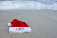A Santa hat on a beach