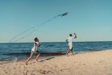 A couple flies a kite on the South Carolina Coast