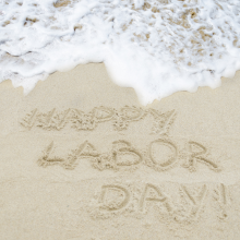 Labor day written in the sand