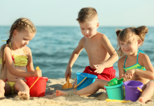Children building a sandcastle on the beach