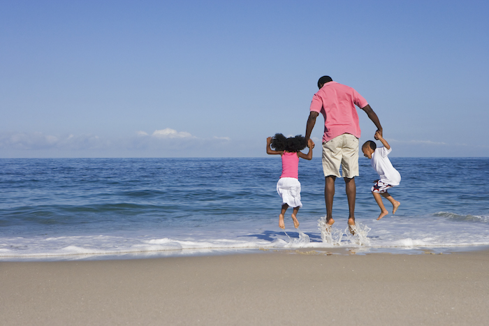 family jumping in water