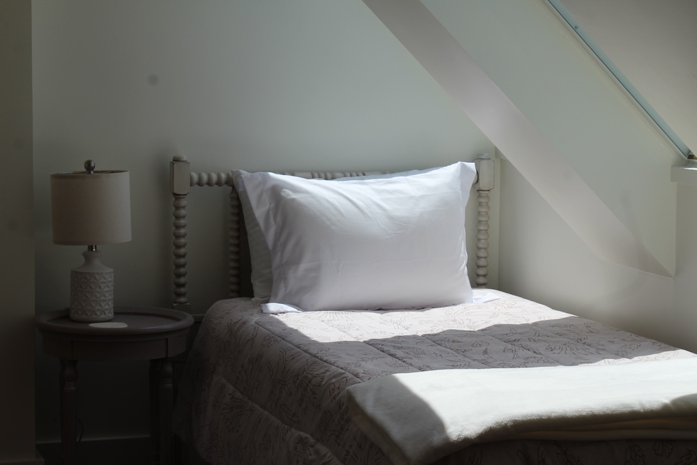 made twin bed with pink bedding