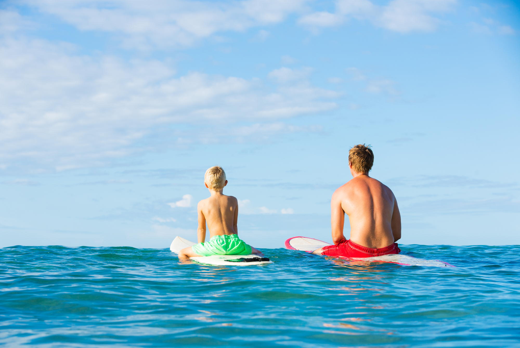 2 surfers on water